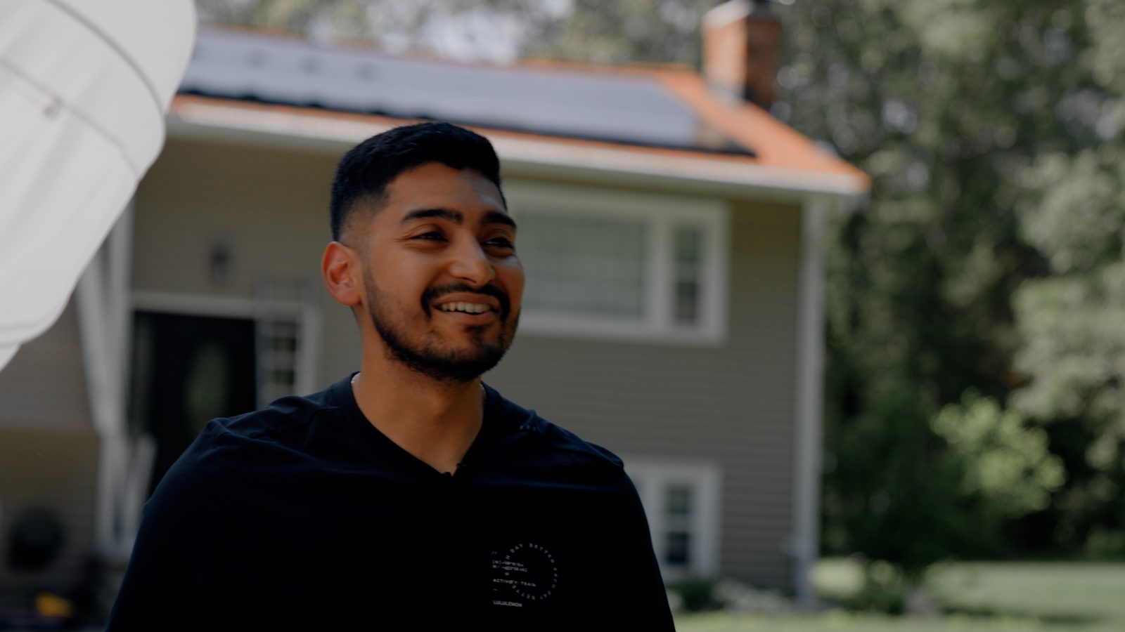 A Bright Home Solutions customer standing in front of his home after a solar and heat pump install