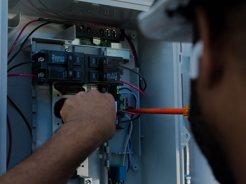 BHS electrician working inside a home electrical panel